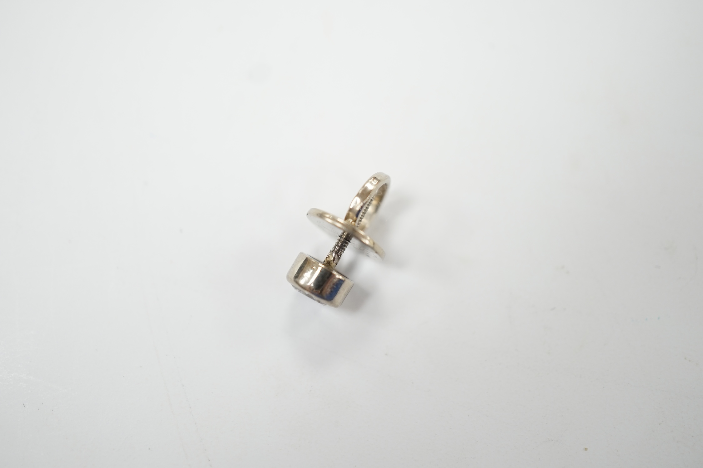 A white metal mounted solitaire diamond set tie stud, the stone measuring approximately 5mm in diameter, gross weight 1.6 grams. Good condition.